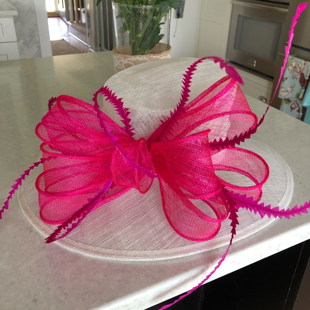 Ivory derby hat with fuchsia sinamay bow